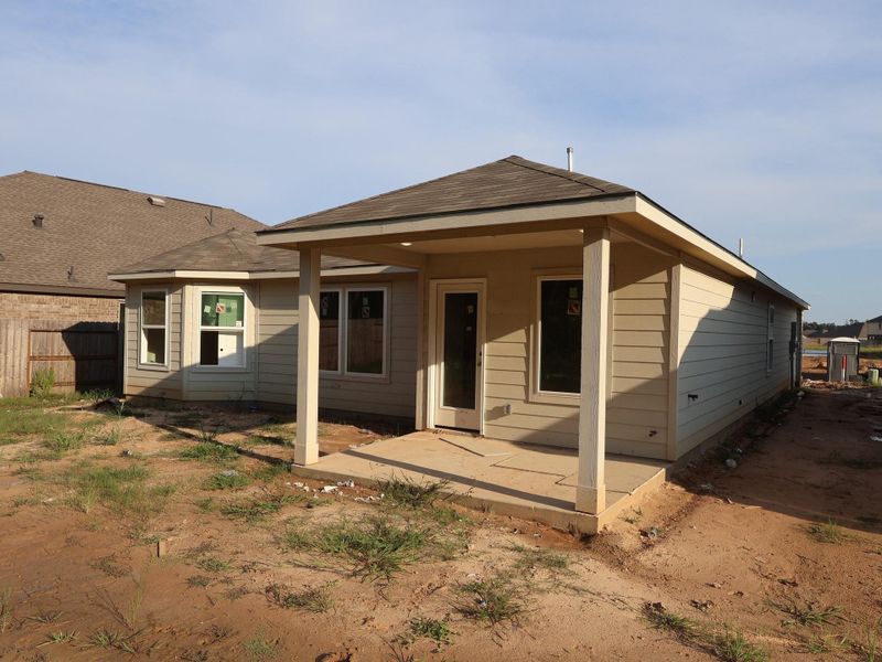 Front exterior of a new home in Pinewood at Grand Texas, New Caney, TX, highlighting curb appeal (Image 15).