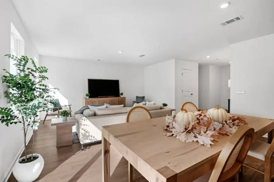 A living room with a table and chairs.