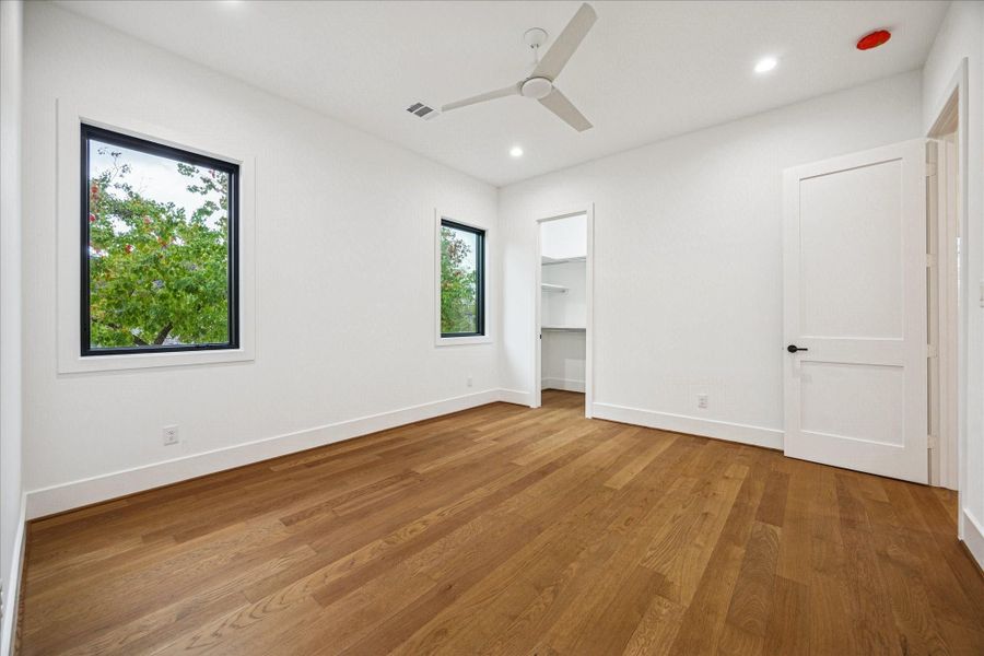 Large Pella windows frame leafy views while generous floor space supports flexible layouts. The en-suite bath and ample closet storage enhance everyday comfort. *Previous Project*