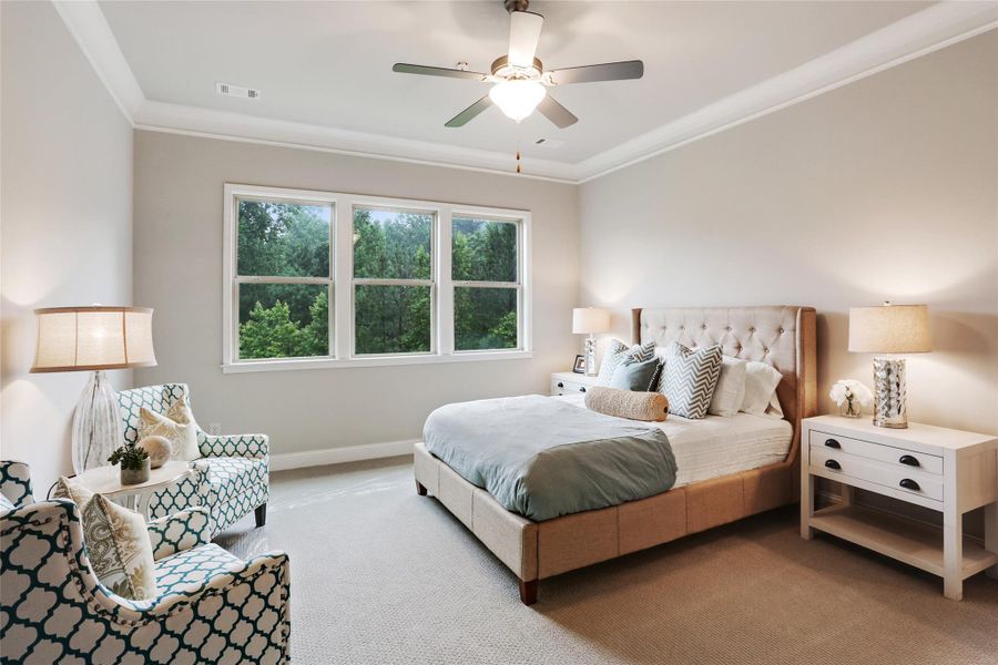 Bedroom featuring ornamental molding, carpet floors, and a ceiling fan Bedroom featuring ornamental molding, carpet floors, and a ceiling fan