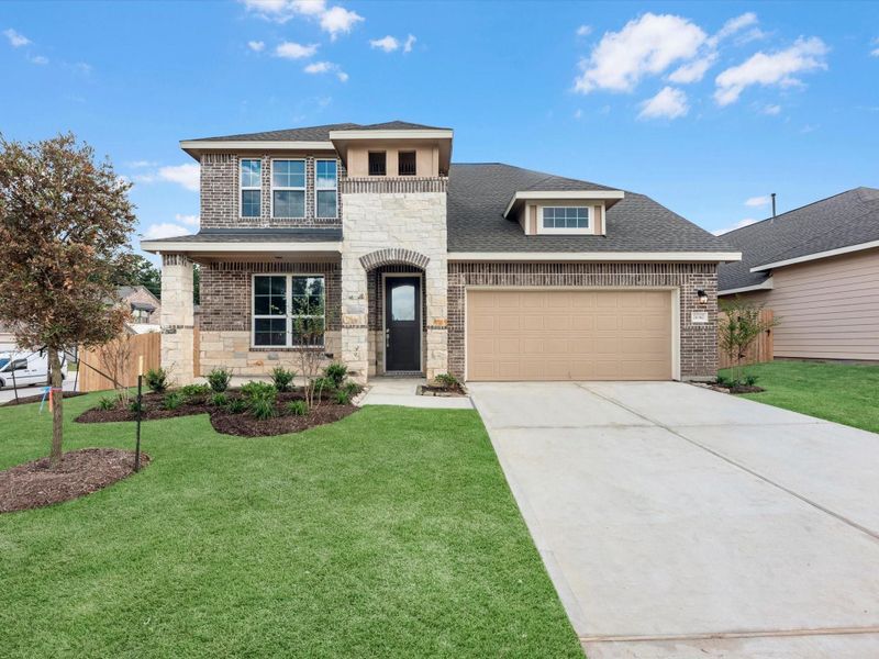 Front exterior of a new home in Spring Creek Trails, Magnolia, TX, highlighting curb appeal (Image 1). Front exterior of a new home in Spring Creek Trails, Magnolia, TX, highlighting curb appeal (Image 1).