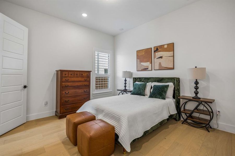 Bedroom with light wood finished floors and recessed lighting