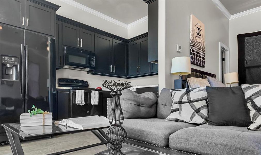 Living area with ornamental molding and light wood-style floors