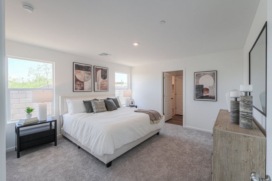 A bedroom with a bed and a table. A bedroom with a bed and a table.