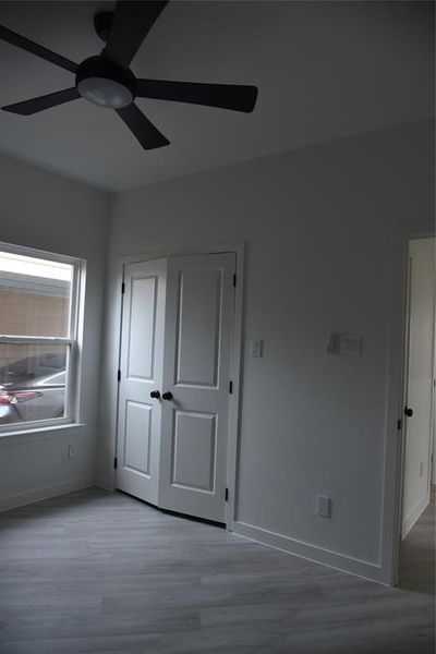 Unfurnished bedroom featuring ceiling fan and light hardwood / wood-style flooring