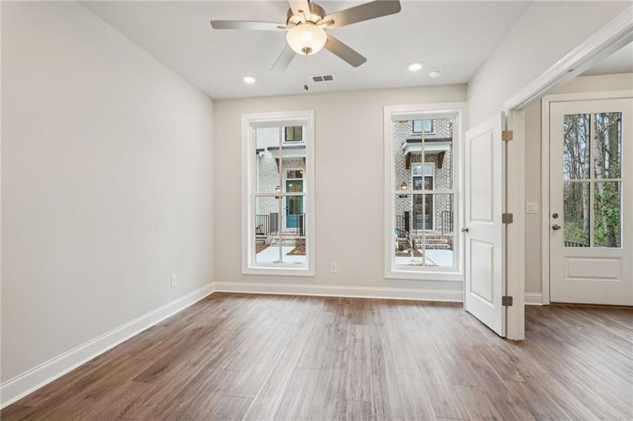 Spare room featuring wood finished floors, ceiling fan, and recessed lighting