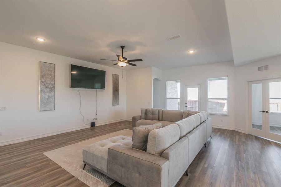 Living room with dark hardwood / wood-style floors and ceiling fan