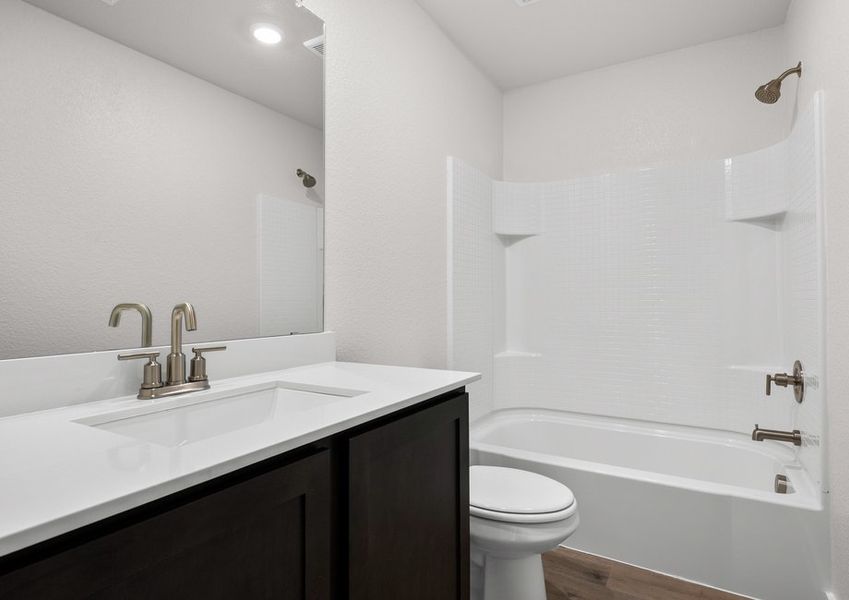 The secondary bathroom has a sprawling vanity and shower-tub combo. The secondary bathroom has a sprawling vanity and shower-tub combo.