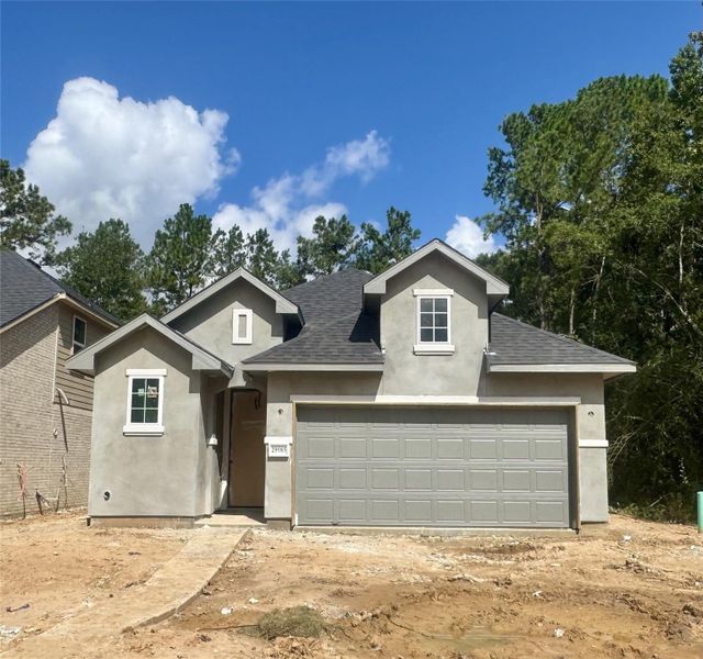 Front exterior of a new home in Woodhavyn 40', Magnolia, TX, highlighting curb appeal (Image 1).