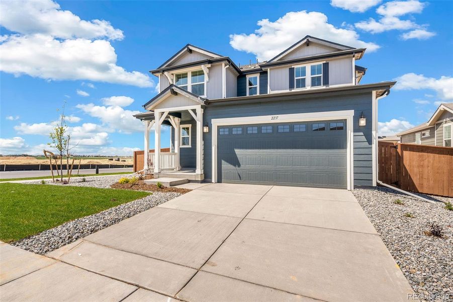 Front exterior of a new home in Farmlore, Brighton, CO, highlighting curb appeal (Image 2).