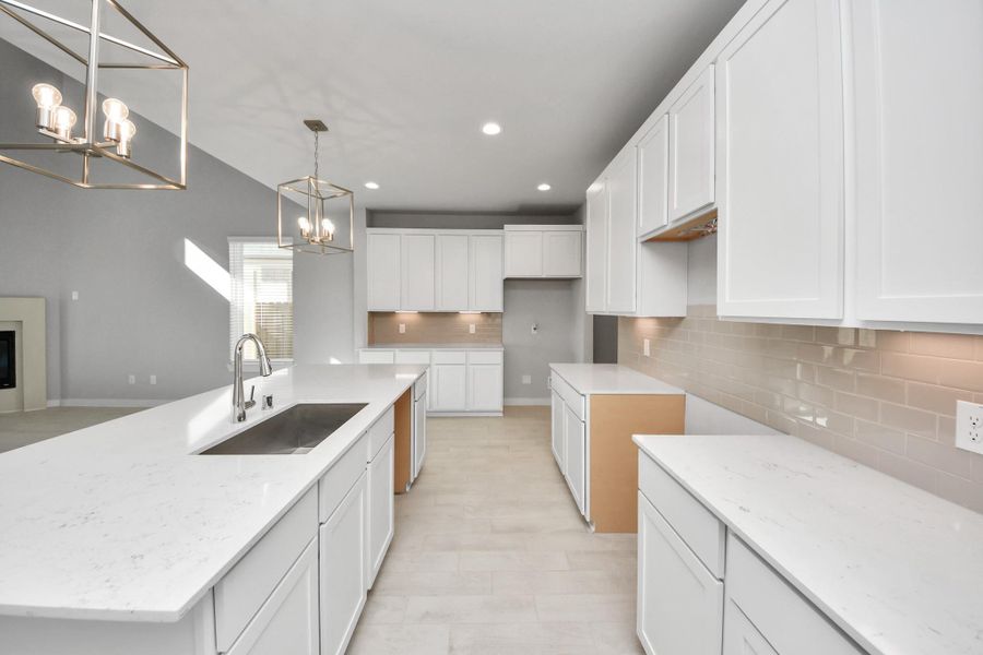 The open concept effortlessly connects the kitchen to the expansive family room, forming a perfect hub for gatherings. This seamless flow creates an inviting space where cooking and socializing come together harmoniously. Sample photo of completed home with similar floor plan. Actual colors and selections may vary. The open concept effortlessly connects the kitchen to the expansive family room, forming a perfect hub for gatherings. This seamless flow creates an inviting space where cooking and socializing come together harmoniously. Sample photo of completed home with similar floor plan. Actual colors and selections may vary.