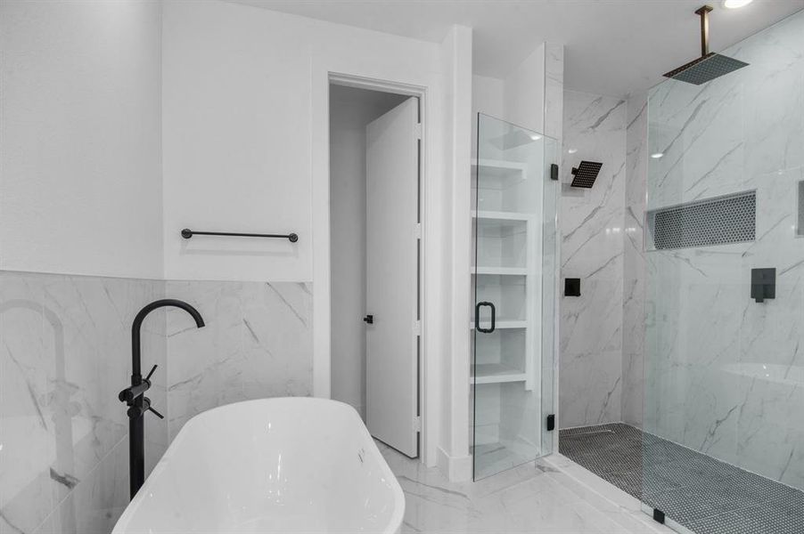 Bathroom with tile walls and separate shower and tub