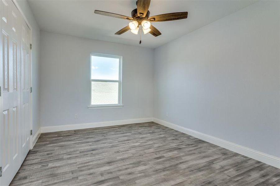 Unfurnished room featuring ceiling fan and light hardwood / wood-style flooring