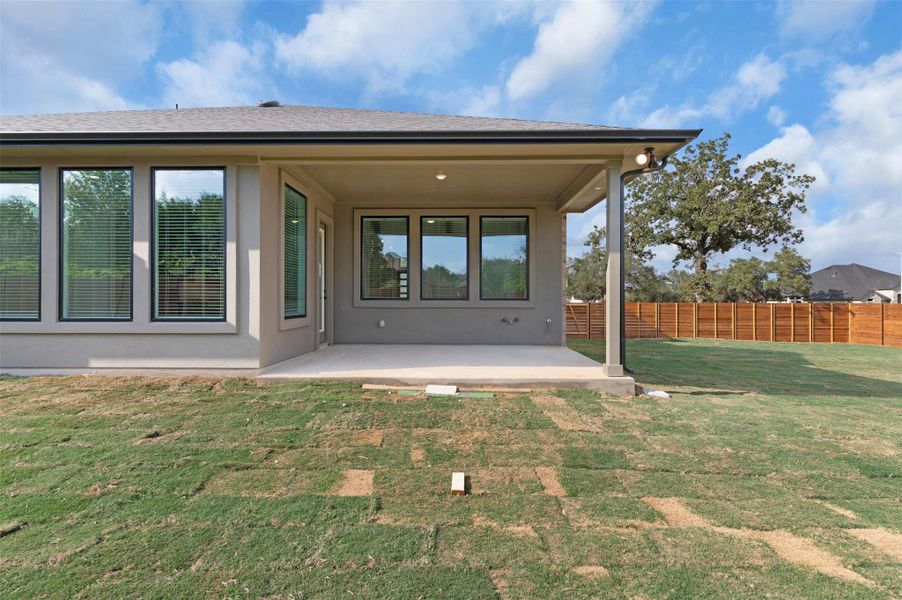Rear view of house featuring a patio area, a fenced backyard, and stucco siding Rear view of house featuring a patio area, a fenced backyard, and stucco siding