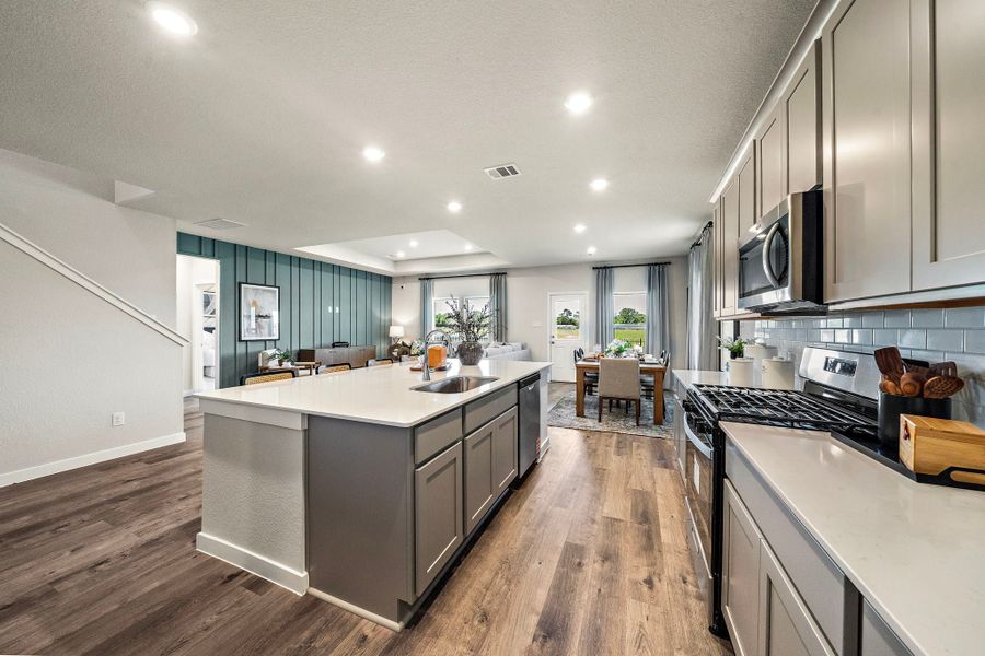 A kitchen with a wood floor. A kitchen with a wood floor.