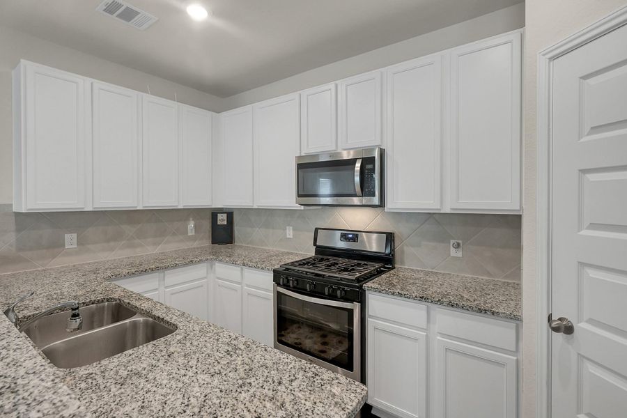 Plenty of cabinet space and an undermount sink in this gally kitchen