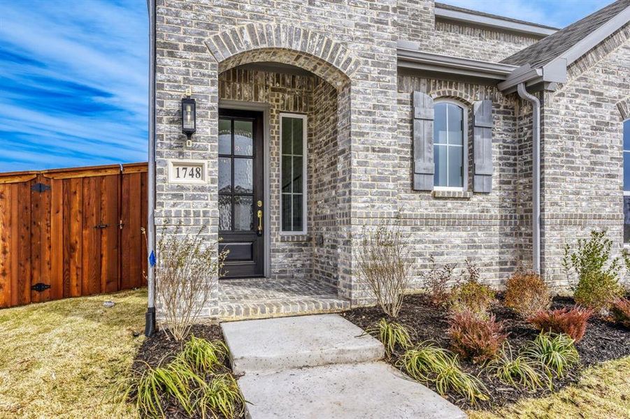 Doorway to property featuring brick siding