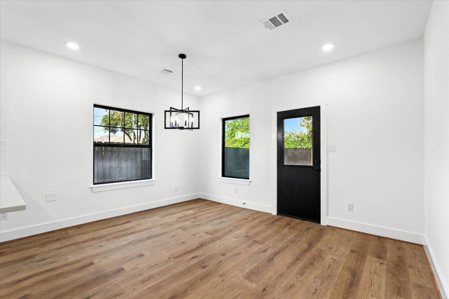 An ample dining area offers plenty of light and easy access to your fenced in backyard.