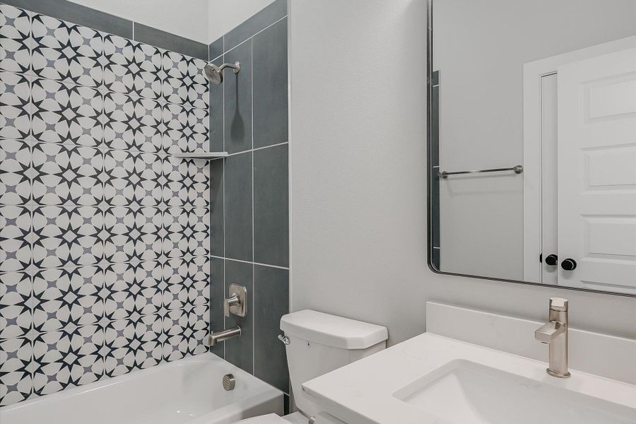 Bathroom featuring washtub / shower combination, vanity, and toilet