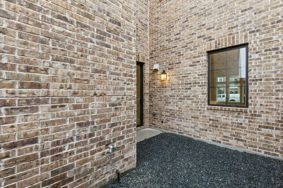 Exterior details and patio area of a home in Newman Village Townhomes, Frisco (Image 3).