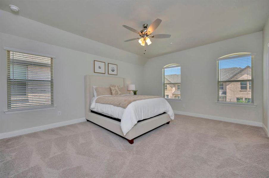Spacious Primary Bedroom with room for large furniture and seating area.