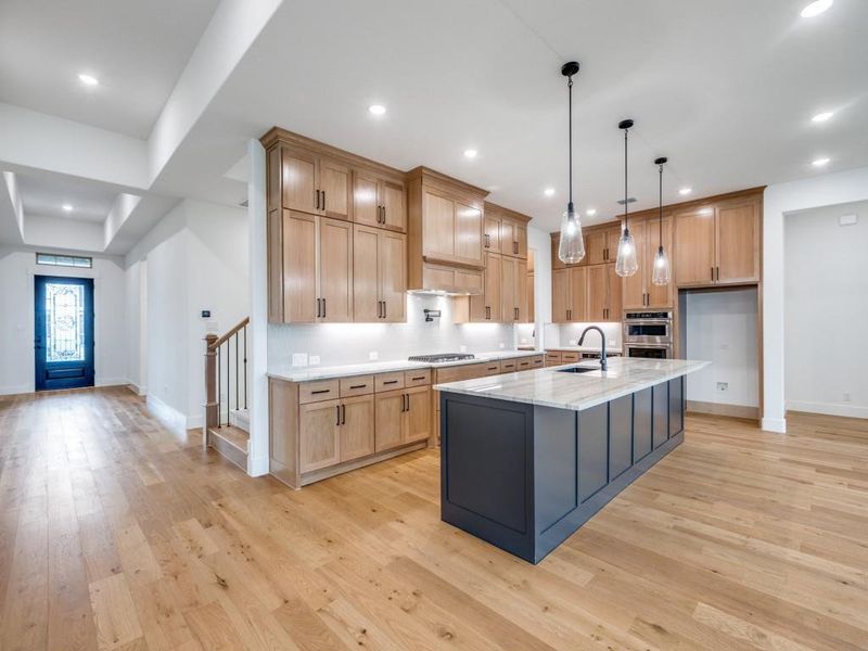 Offering gorgeous flooring, dual stacked cabinetry and an oversized island, this dream kitchen is everything you have been searching for!