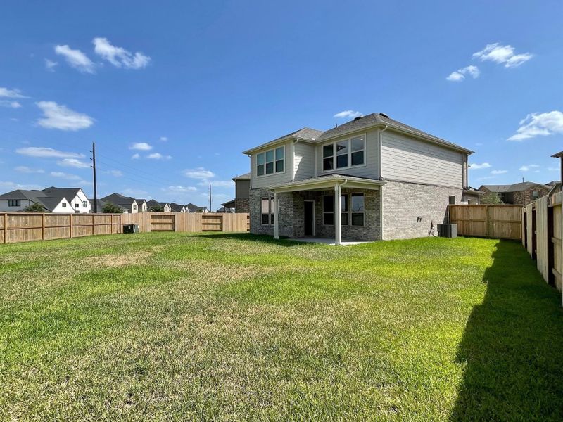 Front exterior of a new home in Sunterra, Katy, TX, highlighting curb appeal (Image 12). Front exterior of a new home in Sunterra, Katy, TX, highlighting curb appeal (Image 12).