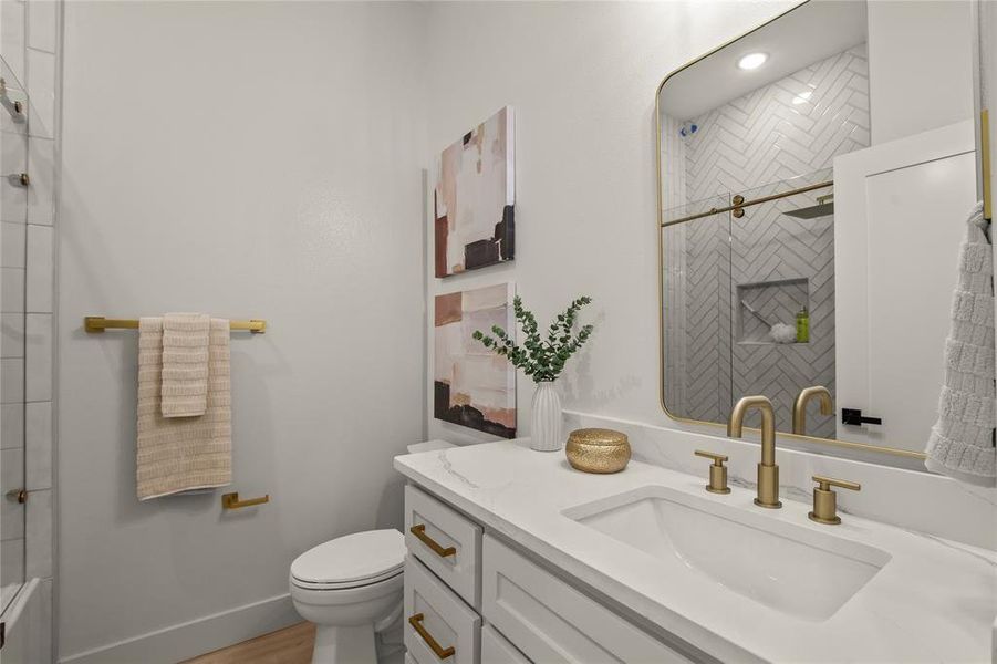 Full bathroom featuring a shower with shower door, vanity, and toilet Full bathroom featuring a shower with shower door, vanity, and toilet