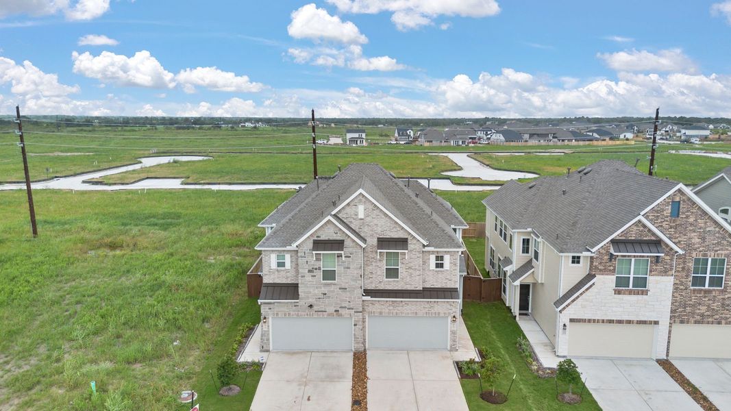 Front exterior of a new home in Meridiana, Manvel, TX, highlighting curb appeal (Image 17).