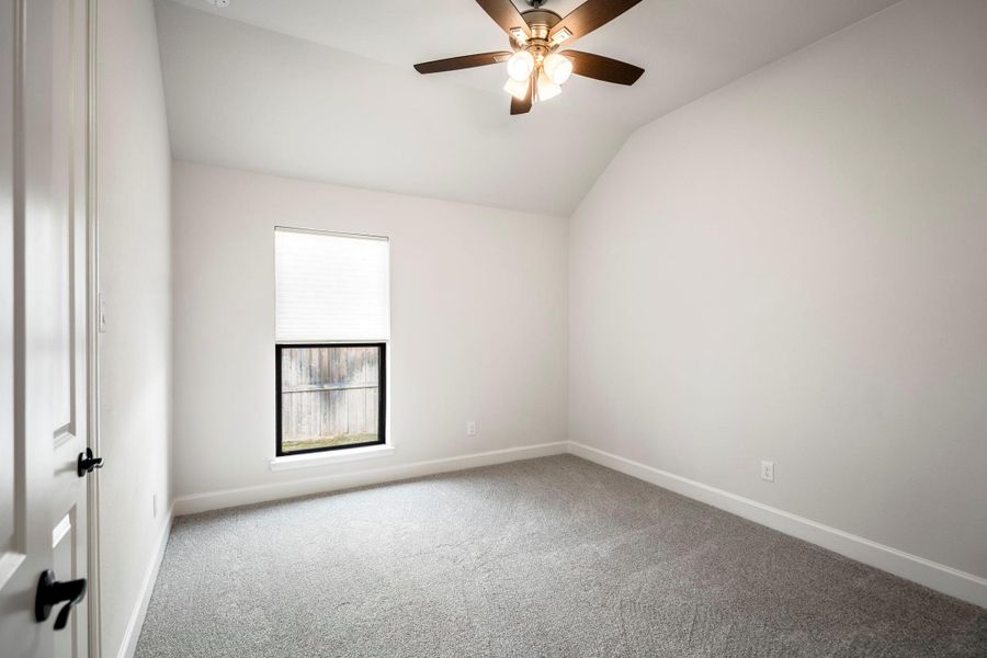 Bedroom #3 with tall ceilings and walk-in closet.