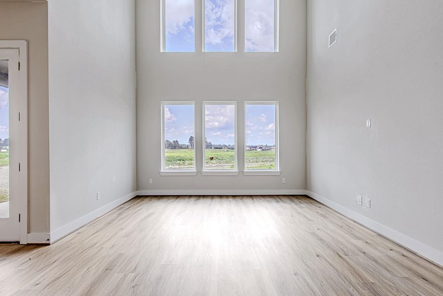 Soaring ceilings and a wall of windows flood the living space with natural light, offering peaceful views and an airy, open ambiance. Soaring ceilings and a wall of windows flood the living space with natural light, offering peaceful views and an airy, open ambiance.