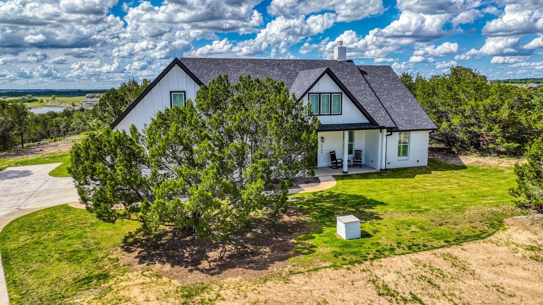 Representative exterior photo of a completed home built from the Lakeshore by Zeal Home Builders in Oak Water Ranch, Granbury, TX (Image 14). Representative exterior photo of a completed home built from the Lakeshore by Zeal Home Builders in Oak Water Ranch, Granbury, TX (Image 14).
