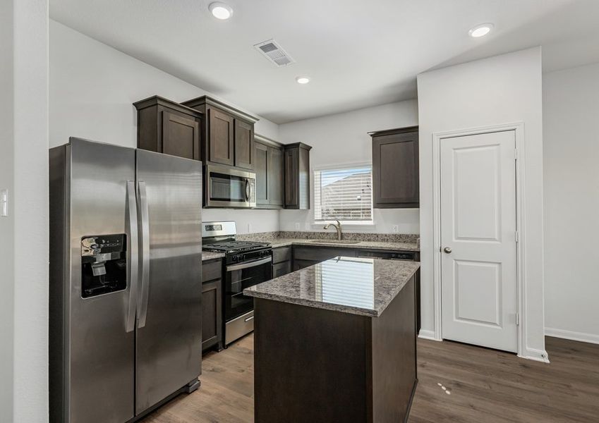 The kitchen has energy-efficient, stainless-steel appliances.