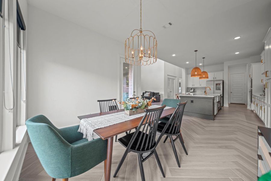 Dining area connects directly to the kitchen for convenience, highlighted by large windows and beautiful lighting. Dining area connects directly to the kitchen for convenience, highlighted by large windows and beautiful lighting.