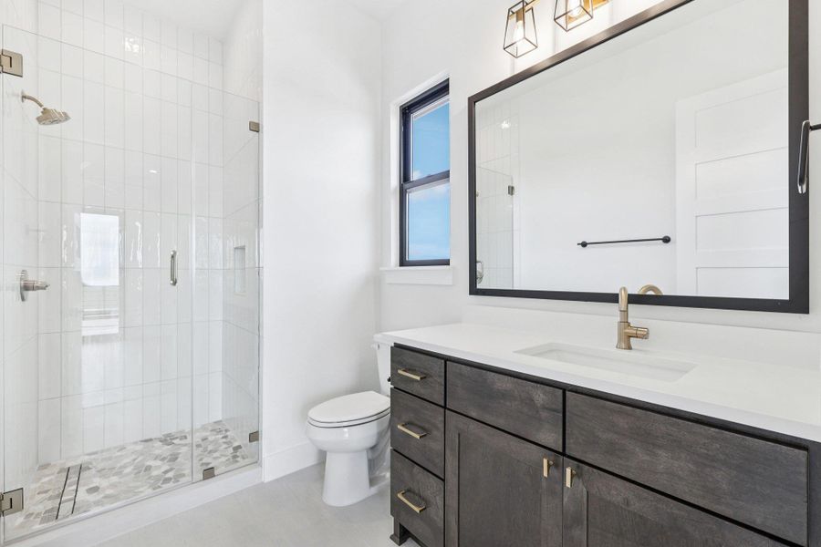 Bathroom featuring vanity, a stall shower, and light tile patterned floors