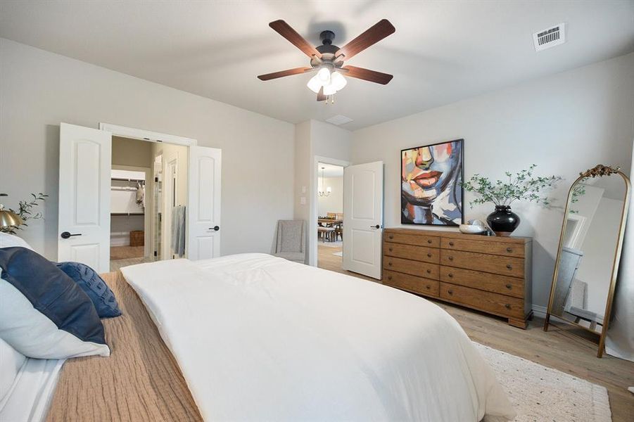 Bedroom featuring light wood-type lux vinyl flooring and a ceiling fan