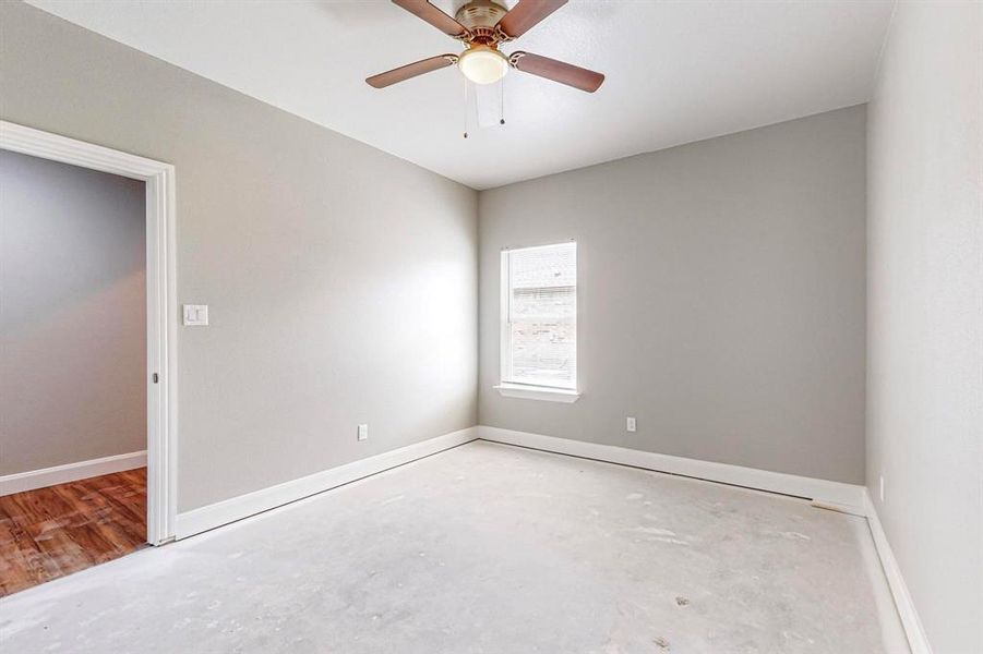 Spare room featuring wood-type flooring and ceiling fan