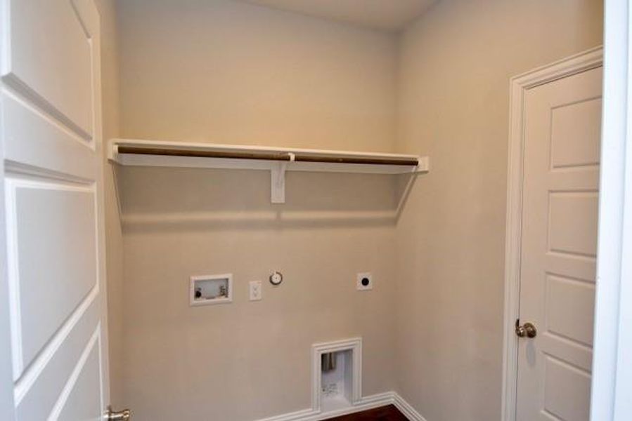 Laundry room featuring hookup for a gas dryer, hookup for an electric dryer, washer hookup, and dark wood-type flooring Laundry room featuring hookup for a gas dryer, hookup for an electric dryer, washer hookup, and dark wood-type flooring