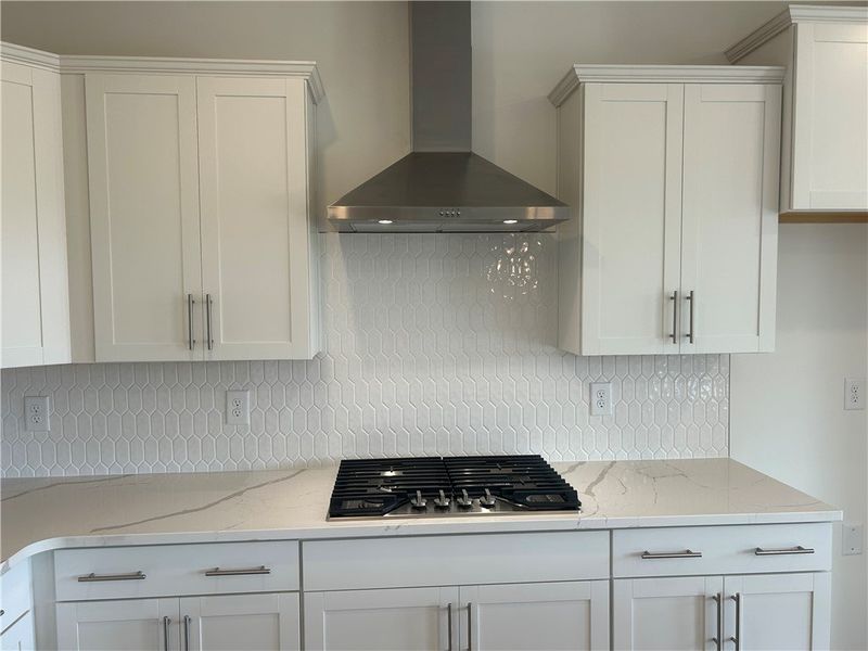 A well-lit kitchen featuring elegant white cabinet