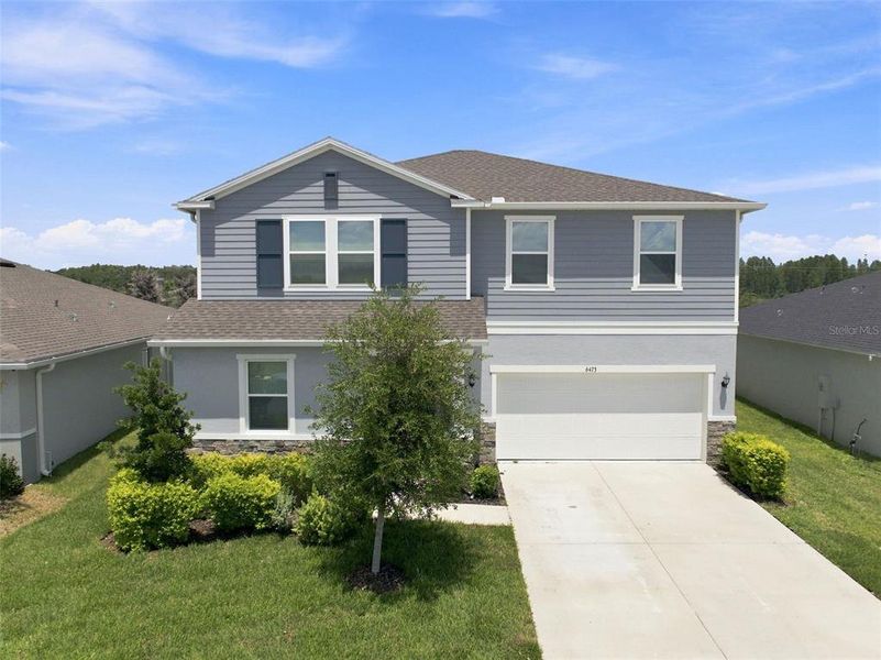 Front exterior of a new home in , Land O' Lakes, FL, highlighting curb appeal (Image 24).
