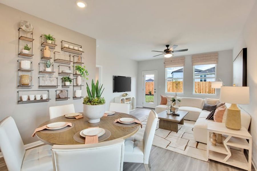 A large living room with a large table and chairs. A large living room with a large table and chairs.