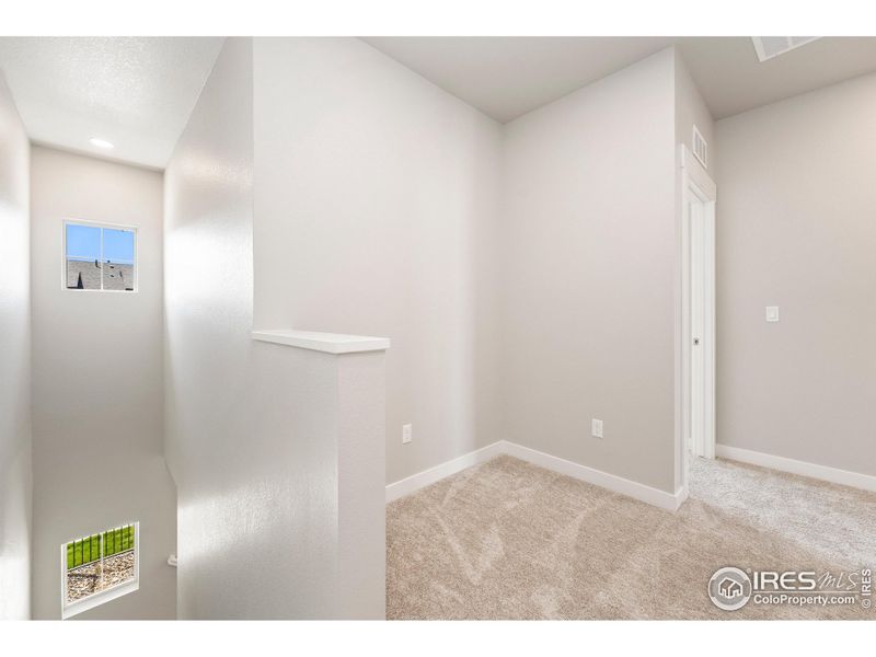 Upstairs loft area perfect for a reading nook or small home office