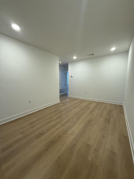 Spare room with wood finished floors and recessed lighting