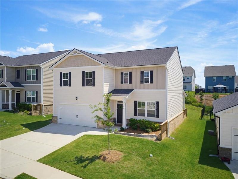 Front exterior of a new home in Twin Lakes, Hoschton, GA, highlighting curb appeal (Image 29). Front exterior of a new home in Twin Lakes, Hoschton, GA, highlighting curb appeal (Image 29).