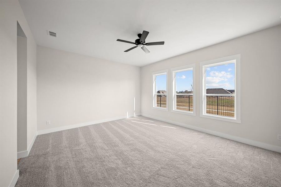 Carpeted empty room with baseboards and ceiling fan