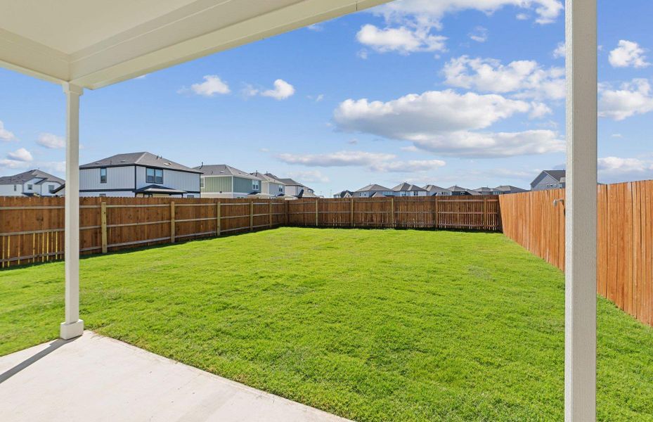 Fenced backyard featuring a patio and a residential view Fenced backyard featuring a patio and a residential view