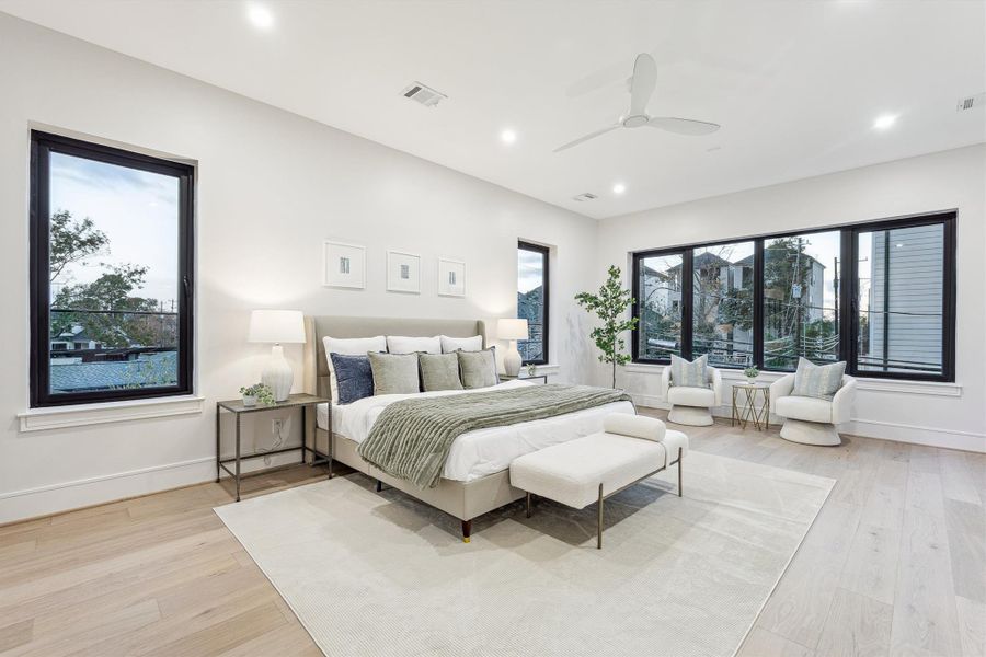 The expansive primary suite on the second floor - is filled with natural light and includes a dry bar with a beverage cooler, as well as a dedicated seating area.