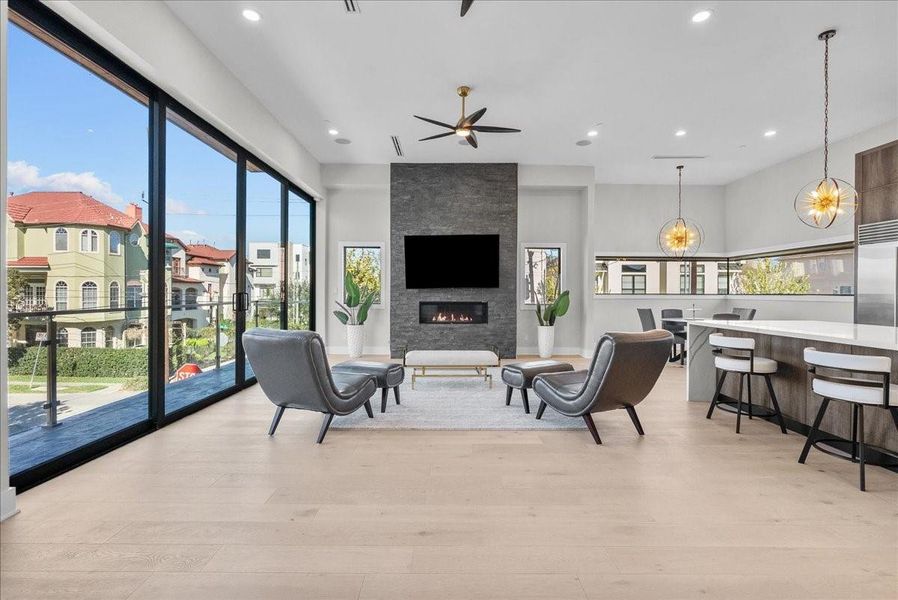 Introducing an oversized living room anchored by a beautiful stone-accented fireplace and opening to a large balcony with expansive decking — creating a seamless indoor-outdoor feel with stunning details throughout. Introducing an oversized living room anchored by a beautiful stone-accented fireplace and opening to a large balcony with expansive decking — creating a seamless indoor-outdoor feel with stunning details throughout.