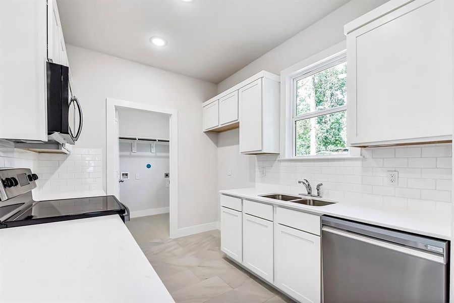 view of laundry room from island.