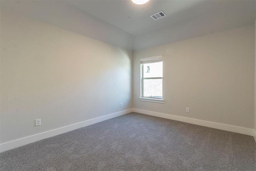 Carpeted empty room with baseboards